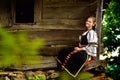 Young Romanian girl smiling on the porch of an old house