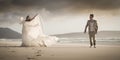 Young romantic bridal couple outdoors flirting on beach Royalty Free Stock Photo