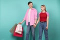 Young romantic couple in casual clothing wallking hand in hand after shopping together Royalty Free Stock Photo