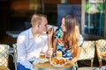 Young romantic couple in a cozy outdoor cafe in Paris, France Royalty Free Stock Photo