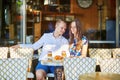 Young romantic couple in a cozy outdoor cafe in Paris, France Royalty Free Stock Photo