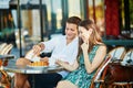 Young romantic couple in a cozy outdoor cafe in Paris, France Royalty Free Stock Photo