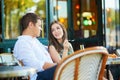 Young romantic couple in a cozy outdoor cafe in Paris, France Royalty Free Stock Photo