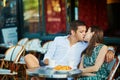 Young romantic couple in a cozy outdoor cafe in Paris, France Royalty Free Stock Photo