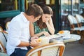 Young romantic couple in a cozy outdoor cafe in Paris, France Royalty Free Stock Photo