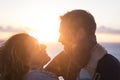 Young romantic couple embracing outdoors during sunset. Close up of loving couple spending leisure time on holiday. Smiling Royalty Free Stock Photo