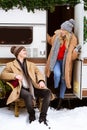 Young romantic couple enjoying traveling with campervan, spending winter day outside