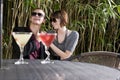 Young romantic couple having drinks on patio Royalty Free Stock Photo