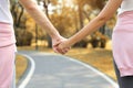 Young romantic couple holding hands and walking together in the park in autumn vacation or valentine concept Royalty Free Stock Photo