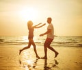 Young, romantic couple hugging on the tropical beach