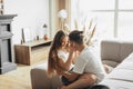 Young romantic couple is kissing and enjoying the company of each other at home Royalty Free Stock Photo