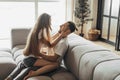 Young romantic couple is kissing and enjoying the company of each other at home Royalty Free Stock Photo