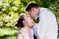 Young romantic couple kissing with love in summer park. Royalty Free Stock Photo