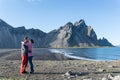 Young romantic couple kissing at a scenic beach in Stokksnes. Iceland. Royalty Free Stock Photo