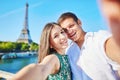 Young romantic couple making selfie near the Eiffel tower Royalty Free Stock Photo