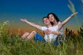 Young romantic couple open arms and having fun at sunset on outdoor, dark night sky, love tenderness concept, young adult people