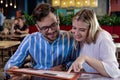 Young romantic couple ordering dinner together in a restaurant. Royalty Free Stock Photo