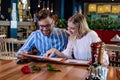 Young romantic couple ordering dinner together in a restaurant. Royalty Free Stock Photo