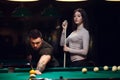 Young romantic couple playing billiard game