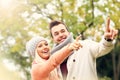 Young romantic couple pointing in the park in autumn Royalty Free Stock Photo