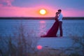 Young romantic couple relaxing on the beach watching the sunset Royalty Free Stock Photo