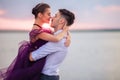 Young romantic couple relaxing on the beach watching the sunset Royalty Free Stock Photo