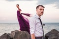 Young romantic couple relaxing on the beach watching the sunset Royalty Free Stock Photo