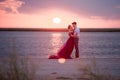 Young romantic couple relaxing on the beach watching the sunset Royalty Free Stock Photo