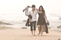 Young romantic couple walking along beach