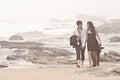 Young romantic couple walking long beach