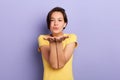 Young romantic cute girl blowing kiss at camera isolated on the blue background