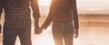 Young loving couple holding hands at sunset Royalty Free Stock Photo