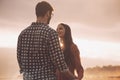 Young loving couple holding hands at sunset Royalty Free Stock Photo