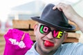 A young, romantic, smiling guy in dark glasses with the inscription love and berry strawberries in his mouth gives a bouquet of Royalty Free Stock Photo