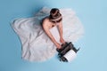 young romantic woman is an author at a typewriter, sitting on the floor in a fluffy white skirt