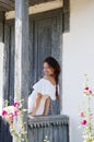 Young romantic woman in white dress at village cottage house in summer countryside outdoor. Beautiful girl Royalty Free Stock Photo