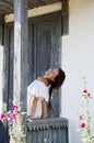 Young romantic woman in white dress at village cottage house in summer countryside outdoor. Beautiful woman Royalty Free Stock Photo