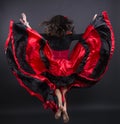 Young romany woman fly in spanish traditional clothes