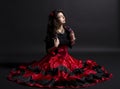 Young romany woman sit in spanish traditional clothes