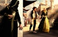 A young royal couple walks hand in hand, oblivious to the lurking Assassin Royalty Free Stock Photo