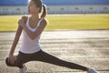 Young runner fit woman streching before exercises outdoors. Athletic female strech after workout outside. Sport and