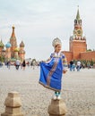 Young russian girl wearing traditional costume at Red square in Moscow