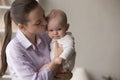 Young loving mother kissing her sweet baby, close up shot Royalty Free Stock Photo
