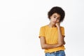 Young sad african woman looking bored or unamused, reluctant upset face, gloomy emotion, standing over white background