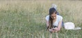 Young sad beautiful woman texting message on mobile phone in urban park - Teenager model girl with worried facial expression hold Royalty Free Stock Photo