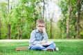 Young sad boy with a books and laptop Royalty Free Stock Photo