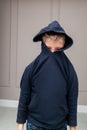 young sad boy in hood looking down and worried of problem at school. Bullying, depression, child protection or loneliness concept Royalty Free Stock Photo