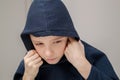 young sad boy in hood looking down and worried of problem at school. Bullying, depression, child protection or loneliness concept Royalty Free Stock Photo