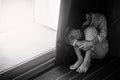 Young sad boy sitting on the floor Royalty Free Stock Photo