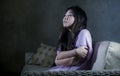 Young sad and depressed Asian Japanese woman at home sofa couch crying desperate and helpless suffering anxiety and depression fee Royalty Free Stock Photo